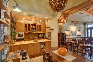 a kitchen and dining room with a table and chairs at Gastronomy Hotel Kritsa in Portaria