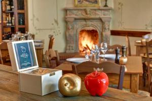 a table with an apple on a table with a fireplace at Gastronomy Hotel Kritsa in Portaria
