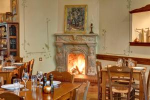 a dining room with a fireplace and tables and chairs at Gastronomy Hotel Kritsa in Portaria