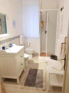 a white bathroom with a toilet and a sink at Duchi in Palermo +90 photos