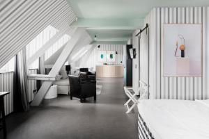 a bedroom with a bed and a living room at Boutique Hotel Helvetia in Zurich