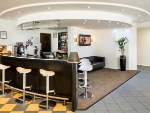 a bar in a restaurant with stools at ibis Preston North in Preston