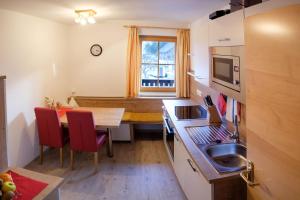 a kitchen with a table and a dining room at Ferienwohnung Schönauer in Haus im Ennstal
