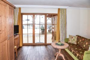 a living room with a couch and a table at Appartementhaus Unterkofler in Grossarl