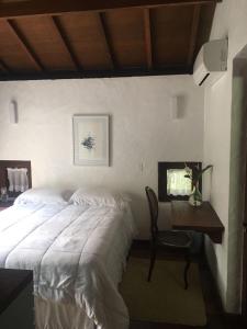 Un pat sau paturi într-o cameră la Casa pé na areia - Praia do Felix