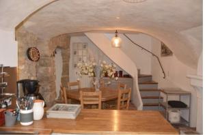 a kitchen and dining room with a table and stairs at Maison d'artiste à Bonnieux in Bonnieux +21 photos