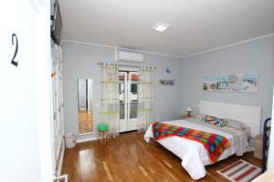 a bedroom with a bed with a colorful blanket at Guest House Pereira in Vila Praia de Âncora +60 photos