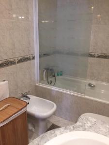 y baño con aseo, bañera y lavamanos. en Viana do Castelo, Cabedelo Beach Apartment, en Viana do Castelo