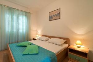 Postel nebo postele na pokoji v ubytování Apartments Ivana-Gustirna