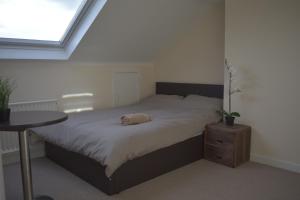 a bed in a room with a table and a window at Home and a Stay in Bristol