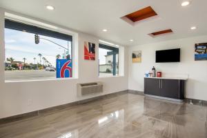 a living room with a tv and a large window at Motel 6-Oceanside, CA, Marina in Oceanside