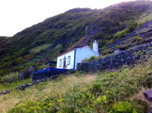 a house on the side of a hill at Casa da Fajãzinha in Vila do Porto
