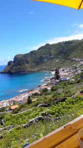 a view of a beach and the ocean at Casa da Fajãzinha in Vila do Porto
