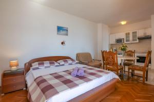 a bedroom with a bed with purple shoes on it at Villa Cetina in Omiš +34 photos