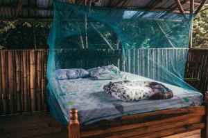 a bed in a tent with two pillows on it at Finca La Magia in Ometepe