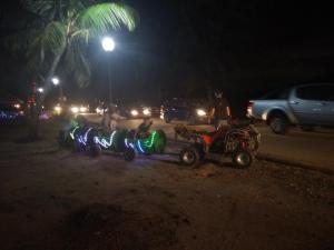 a group of people riding on a trailer at night at Mama Iman Guestroom in Kertih