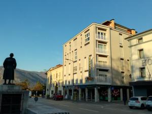 a building with a statue in the middle of a street at Hotel Brennero in Bassano del Grappa