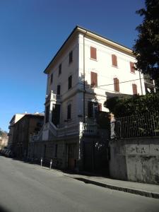 a large white building on the side of a street at VILLA ALMA 2 in Bologna