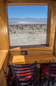 a wooden chair sitting in front of a window at Panamint Springs Motel & Tents in Panamint Springs