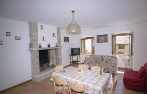 a living room with a table and a fireplace at Appartamenti Serena - Nonna Agnese in Gargnano