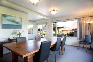 a dining room with a wooden table and chairs at Manuka Lodge B&B in Ohakune
