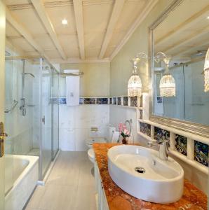 a bathroom with a sink and a shower and a tub at Sacristia de Santa Ana in Seville
