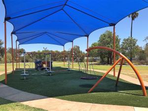 a green and white tent sitting under a blue canopy at Discovery Parks - Kalgoorlie Goldfields in Boulder