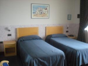 Posteľ alebo postele v izbe v ubytovaní Hotel Roma