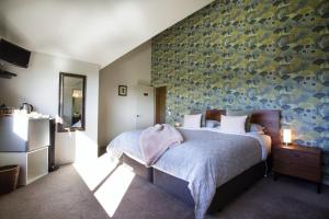 Postel nebo postele na pokoji v ubytování Manuka Lodge B&B