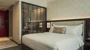 Voodi või voodid majutusasutuse WEIL Hotel Ipoh toas