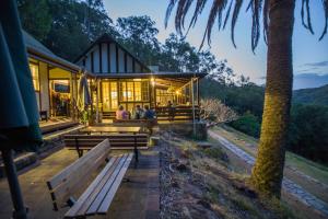 people sitting on benches in front of a building at YHA Pittwater Eco, Sydney in Church Point