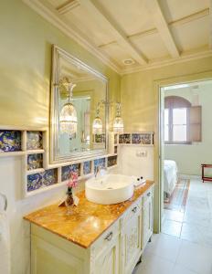 a bathroom with a sink and a mirror at Sacristia de Santa Ana in Seville +20 photos