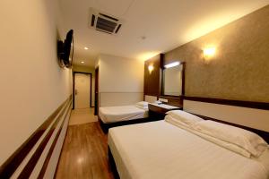 Ένα ή περισσότερα κρεβάτια σε δωμάτιο στο Ming Paragon Hotel +33 φωτογραφίες