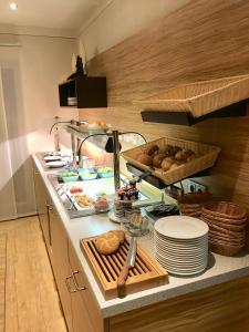 a kitchen with a counter with food on it at Waldgasthof St.Wolfgang in Sinning