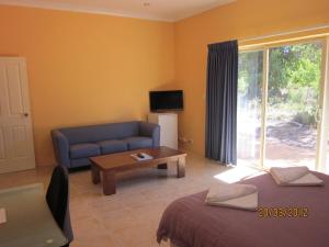 a living room with a couch and a table at Chalets on Stoneville in Stoneville