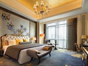 sypialnia z dużym łóżkiem i żyrandolem w obiekcie Wanda Realm Neijiang w mieście Neijiang