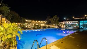 ein großer blauer Swimmingpool bei Nacht in der Unterkunft AU Place Hotel in Loei