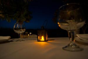 a table with two glasses and a candle on it at Casa Bons Aires in Alcoy