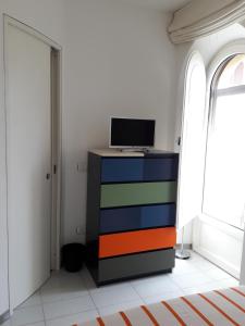 a colorful dresser with a computer on it in a room at B&B Varò Taormina in Taormina