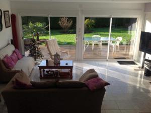 a living room with a couch and a table at La maison de Brijy in Pleslin-Trigavou