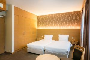 Postel nebo postele na pokoji v ubytování Hotel Bon Repos