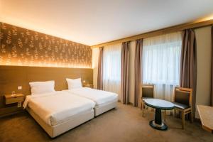 Postel nebo postele na pokoji v ubytování Hotel Bon Repos