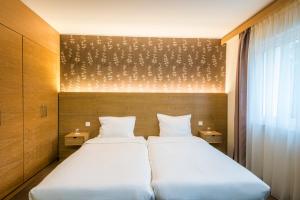 Postel nebo postele na pokoji v ubytování Hotel Bon Repos