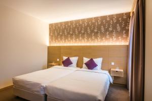 Postel nebo postele na pokoji v ubytování Hotel Bon Repos