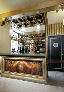a bar with a large painting on the wall at Sacristia de Santa Ana in Seville