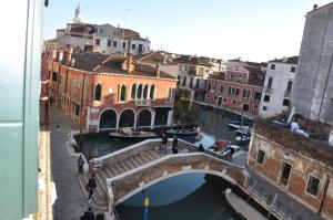 a bridge over a canal in a city with buildings at La Chambre D'Ella in Venice