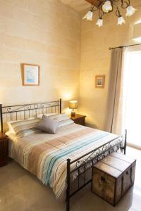斯利馬的住宿－Maltese Town House Sliema，一间卧室设有一张大床和一个窗户。