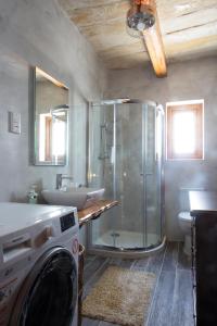 a bathroom with a shower and a washing machine at Maltese Town House Sliema in Sliema