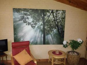 a large painting of trees on a wall at Gästeappartement Appricot in Adendorf +6 photos