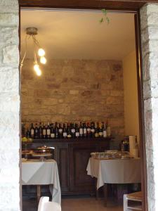 a dining room with two tables and bottles of wine at Appartamenti Poggio Fiorito in Assisi